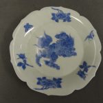 Dish (foliate-shaped). Lion-dog (shishi), plants and butterflies. Made of blue underglaze porcelain.