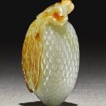 A CELADON AND RUSSET JADE CARVING OF A LYCHEE QING DYNASTY, QIANLONG PERIOD