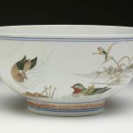 Porcelain bowl painted with enamel colours depicting lotuses, bamboo, water, ducks and other birds. Inside, painted with small red flowers and two butterflies