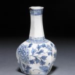 Small hexagonal vase with long neck. Made of porcelain with underglaze blue decoration of peonies and butterflies.
